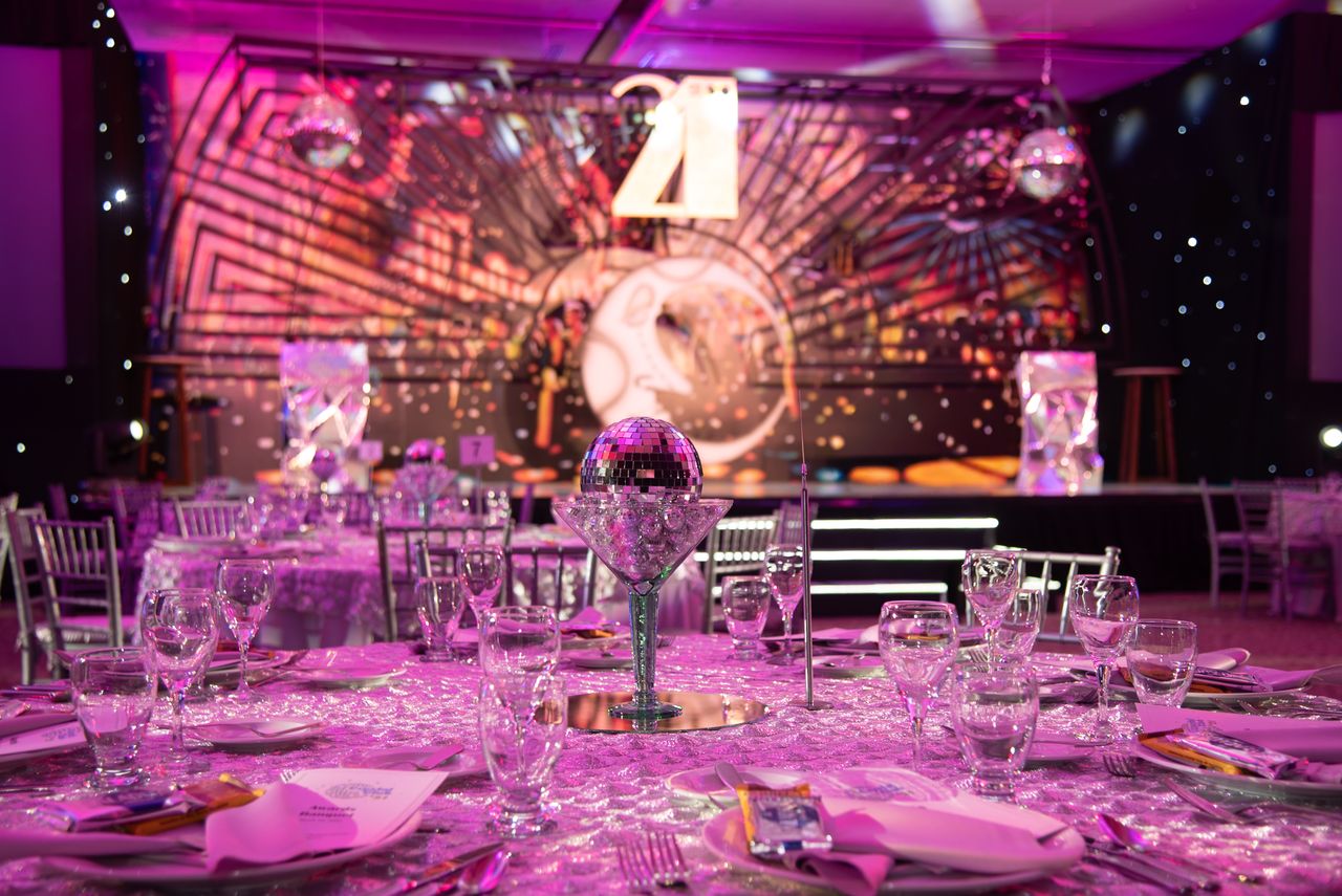 our-story Luxurious dining setup for a 21st birthday party with a sparkling modern theme.